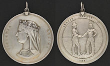 Two sides of a silver medal: the profile of Queen Victoria and the inscription