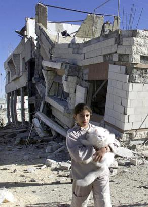 File:Sumayya and her cat in front of her demolished home 2002, 2nd Intifada.jpg