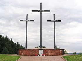 A Memorial consisting of three crosses standing on a large brick pedestal. Each cross bears a name &ndash; Katyn, Kharkiv, or Mednoye.