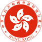 A red circular emblem, with a white 5-petalled flower design in the centre, and surrounded by the words