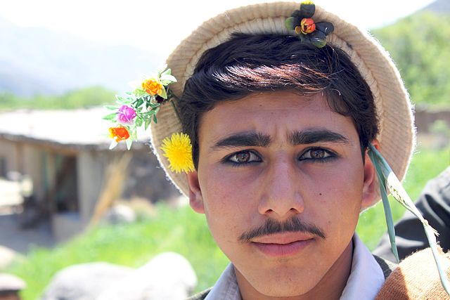 File:Young Pashai man with flowers in his hair.jpg